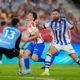 Real Sociedad's Duje Caleta-Car, right, and goalkeeper Unai Marrero, left, challenge for the ball with Atletico Madrid's Julian Alvarez during the Copa del Rey final soccer match between Atletico Madrid and Real Sociedad in Seville, Spain, Saturday, April. 18, 2026. (AP Photo/Jose Breton)