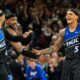Orlando Magic forward Paolo Banchero (5) celebrates with teammates guard Jalen Suggs, left, and center Wendell Carter Jr. after sinking a 3-point shot against the Detroit Pistons during the closing moments of the second half in Game 3 of a first-round NBA basketball playoff series, Saturday, April 25, 2026, in Orlando, Fla. (AP Photo/John Raoux)