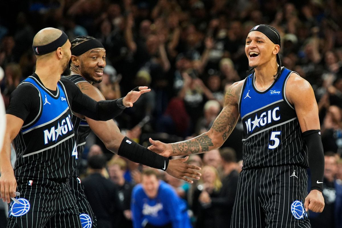 Orlando Magic forward Paolo Banchero (5) celebrates with teammates guard Jalen Suggs, left, and center Wendell Carter Jr. after sinking a 3-point shot against the Detroit Pistons during the closing moments of the second half in Game 3 of a first-round NBA basketball playoff series, Saturday, April 25, 2026, in Orlando, Fla. (AP Photo/John Raoux)