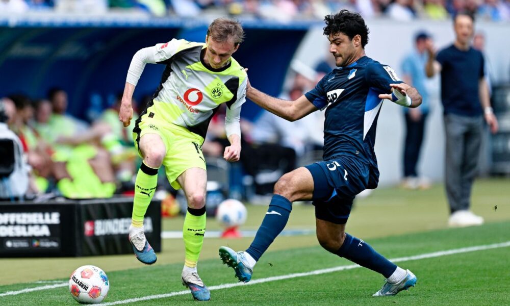 Dortmund's Maximilian Beier, left, and Hoffenheim's Ozan Kabak battle for the ball during their German Bundesliga soccer match in Sinsheim, Germany, Saturday, April 18, 2026. (Uwe Anspach/dpa via AP)