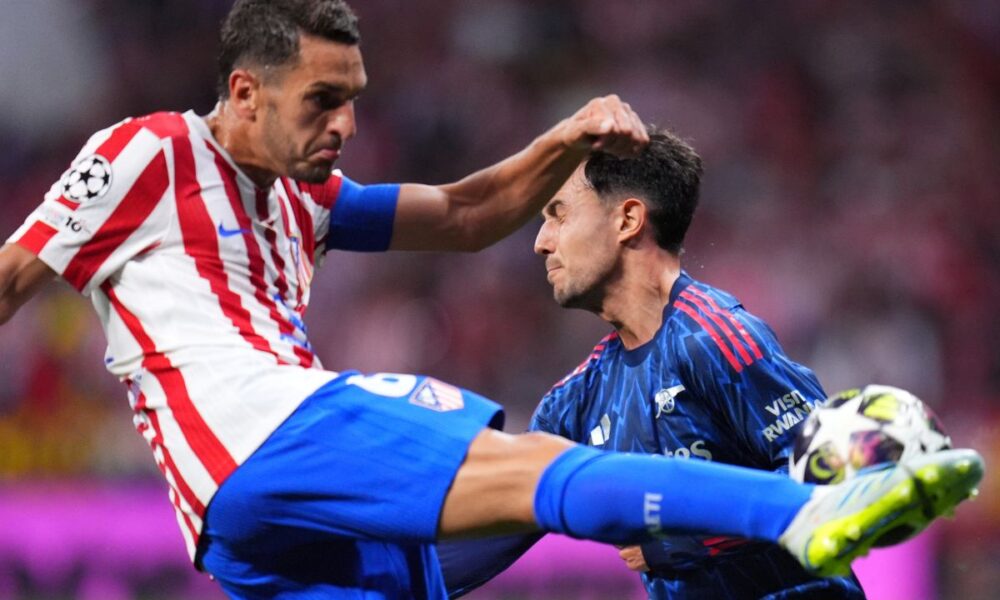 Arsenal's Martin Zubimendi, right, tries to block a shot by Atletico Madrid's Koke during a Champions League semifinal, first leg, soccer match between Atletico Madrid and Arsenal in Madrid, Spain, Wednesday, April 29, 2026. (AP Photo/Manu Fernandez)
