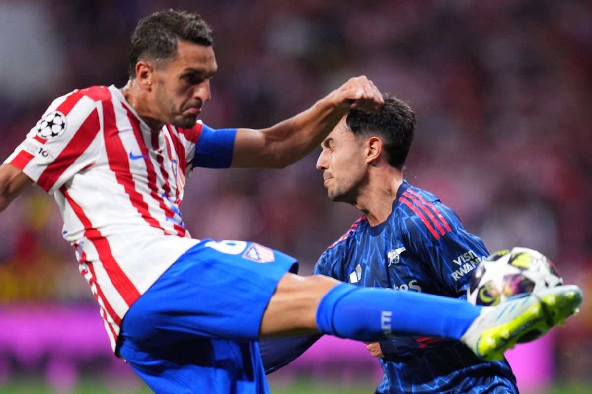 Arsenal's Martin Zubimendi, right, tries to block a shot by Atletico Madrid's Koke during a Champions League semifinal, first leg, soccer match between Atletico Madrid and Arsenal in Madrid, Spain, Wednesday, April 29, 2026. (AP Photo/Manu Fernandez)