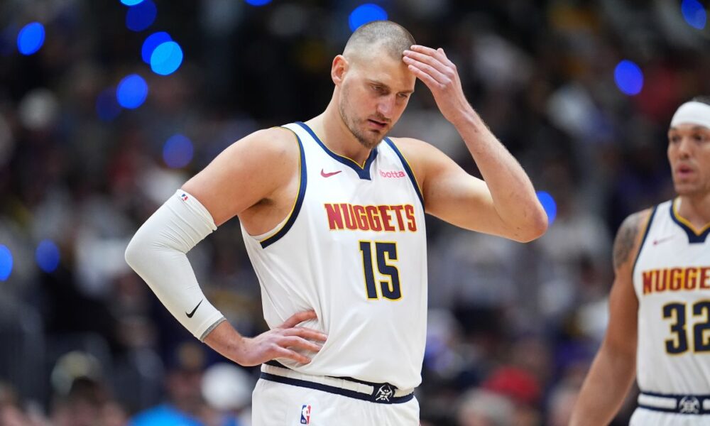 Denver Nuggets center Nikola Jokic waits for tip off in the first half in Game 1 of a first-round NBA playoffs basketball series against the Minnesota Timberwolves Saturday, April 18, 2026, in Denver. (AP Photo/David Zalubowski)