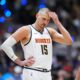 Denver Nuggets center Nikola Jokic waits for tip off in the first half in Game 1 of a first-round NBA playoffs basketball series against the Minnesota Timberwolves Saturday, April 18, 2026, in Denver. (AP Photo/David Zalubowski)