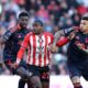 Sunderland's Noah Sadiki, center, and Nottingham Forest's Igor Jesus battle for the ball during the Premier League soccer match between Sunderland and Nottingham Forest, Friday, April 24, 2026, in Sunderland, England. (Richard Sellers/PA via AP)