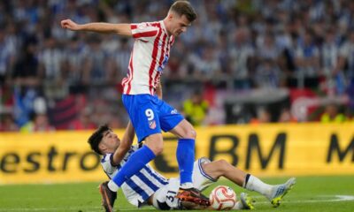 Atletico Madrid's Alexander Sorloth, top, and Real Sociedad's Jon Martin challenge for the ball during the Copa del Rey final soccer match between Atletico Madrid and Real Sociedad in Seville, Spain, Saturday, April. 18, 2026. (AP Photo/Jose Breton)