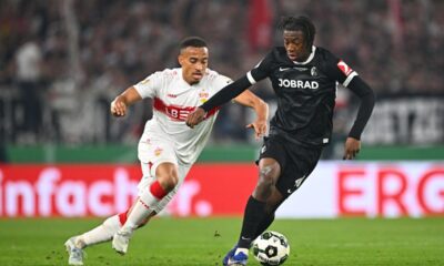Freiburg's Johan Manzambi, right, turns away Stuttgart's Jamie Leweling during a German Cup semifinal soccer match between VfB Stuttgart and SC Freiburg, Thursday, April 23, 2026, in Stuttgart, Germany. (Tom Weller/dpa via AP)