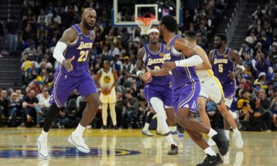 Los Angeles Lakers forward LeBron James (23) congratulates guard Bronny James, front right, after scoring against the Golden State Warriors during the second half of an NBA basketball game in San Francisco, Thursday, April 9, 2026. (AP Photo/Jeff Chiu)