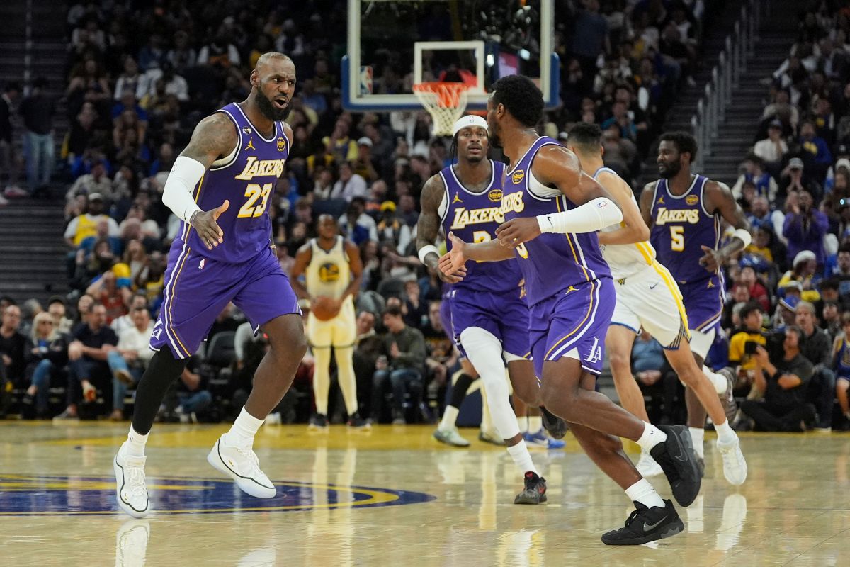 Los Angeles Lakers forward LeBron James (23) congratulates guard Bronny James, front right, after scoring against the Golden State Warriors during the second half of an NBA basketball game in San Francisco, Thursday, April 9, 2026. (AP Photo/Jeff Chiu)