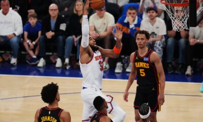 New York Knicks' Karl-Anthony Towns (32) drives past Atlanta Hawks' Dyson Daniels (5) during the first half in Game 1 of a first-round NBA playoffs basketball series, Saturday, April 18, 2026, in New York. (AP Photo/Frank Franklin II)