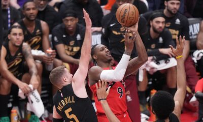 Toronto Raptors forward RJ Barrett (9) drives to the basket as Cleveland Cavaliers guard Sam Merrill (5) and center Jarrett Allen (31) defend during the first half of Game 4 in a first-round NBA basketball playoffs series in Toronto, Sunday, April 26, 2026. (Nathan Denette/The Canadian Press via AP)