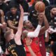 Toronto Raptors forward RJ Barrett (9) drives to the basket as Cleveland Cavaliers guard Sam Merrill (5) and center Jarrett Allen (31) defend during the first half of Game 4 in a first-round NBA basketball playoffs series in Toronto, Sunday, April 26, 2026. (Nathan Denette/The Canadian Press via AP)