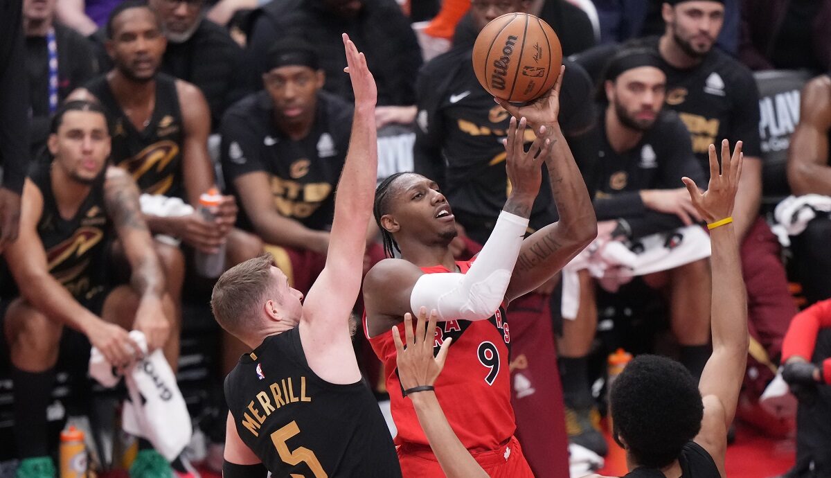 Toronto Raptors forward RJ Barrett (9) drives to the basket as Cleveland Cavaliers guard Sam Merrill (5) and center Jarrett Allen (31) defend during the first half of Game 4 in a first-round NBA basketball playoffs series in Toronto, Sunday, April 26, 2026. (Nathan Denette/The Canadian Press via AP)