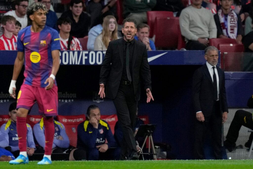 Atletico Madrid's head coach Diego Simeone, reacts as he watches his players from the dugout during a La Liga soccer match between Atletico Madrid and Barcelona in Madrid, Spain, Saturday, April 4, 2026. (AP Photo/Bernat Armangue)