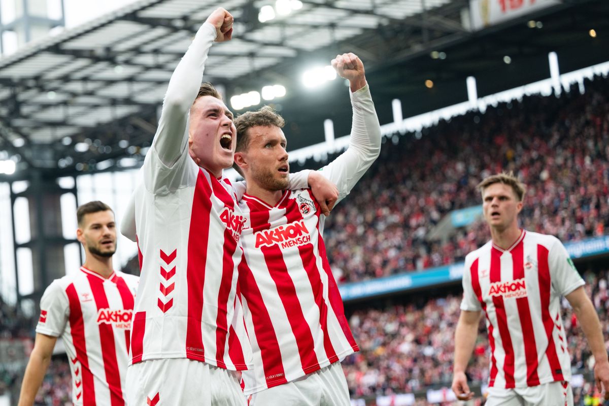 Koln's Isak Johannesson, centre left, celebrates Luca Waldschmidt after scoring his side's third goal with during German Bundesliga soccer match between 1. FC Koln and Werder Bremen and Werder Bremen, in Cologne, Germany, Sunday, April 12, 2026. (Marius Becker/dpa via AP)