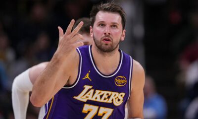 Los Angeles Lakers guard Luka Doncic (77) gestures after a three-point basket against the Indiana Pacers during the first half of an NBA basketball game in Indianapolis, Wednesday, March 25, 2026. (AP Photo/Michael Conroy)