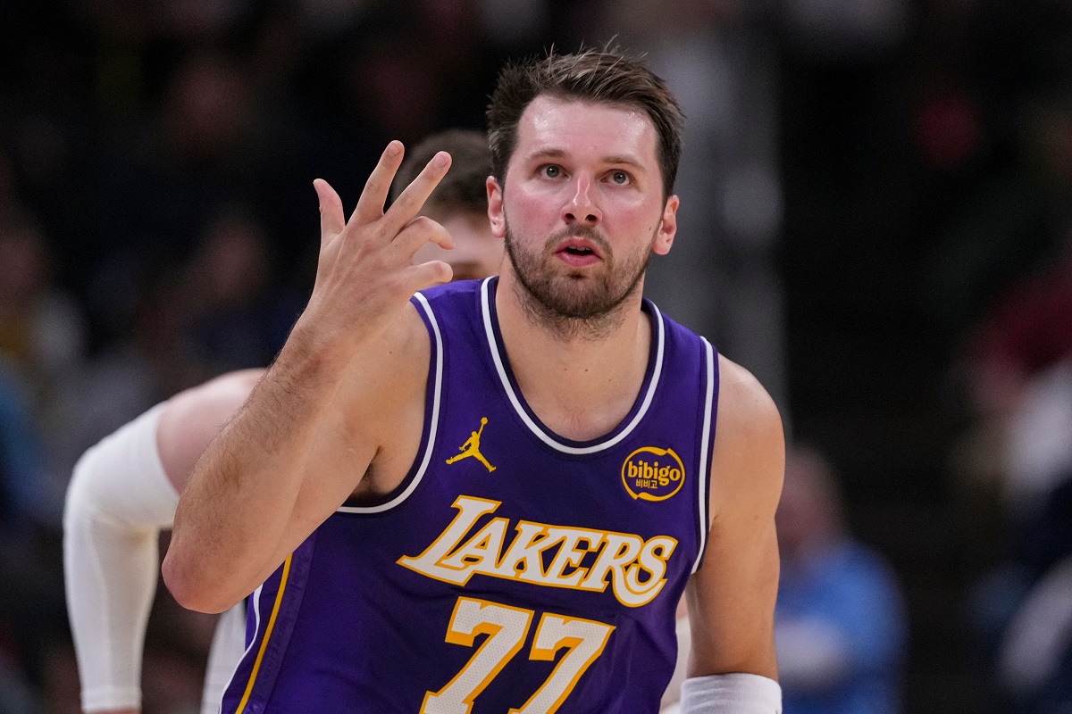 Los Angeles Lakers guard Luka Doncic (77) gestures after a three-point basket against the Indiana Pacers during the first half of an NBA basketball game in Indianapolis, Wednesday, March 25, 2026. (AP Photo/Michael Conroy)