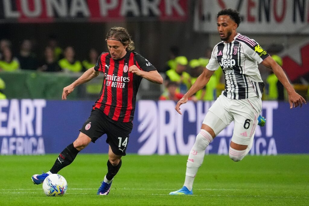 AC Milan's Luka Modric, left, controls the ball from Juventus' Lloyd Kelly during a Serie A soccer match between AC Milan and Juventus, in Milan, Italy, Sunday, April 26, 2026. (Alessio Morgese/LaPresse via AP)