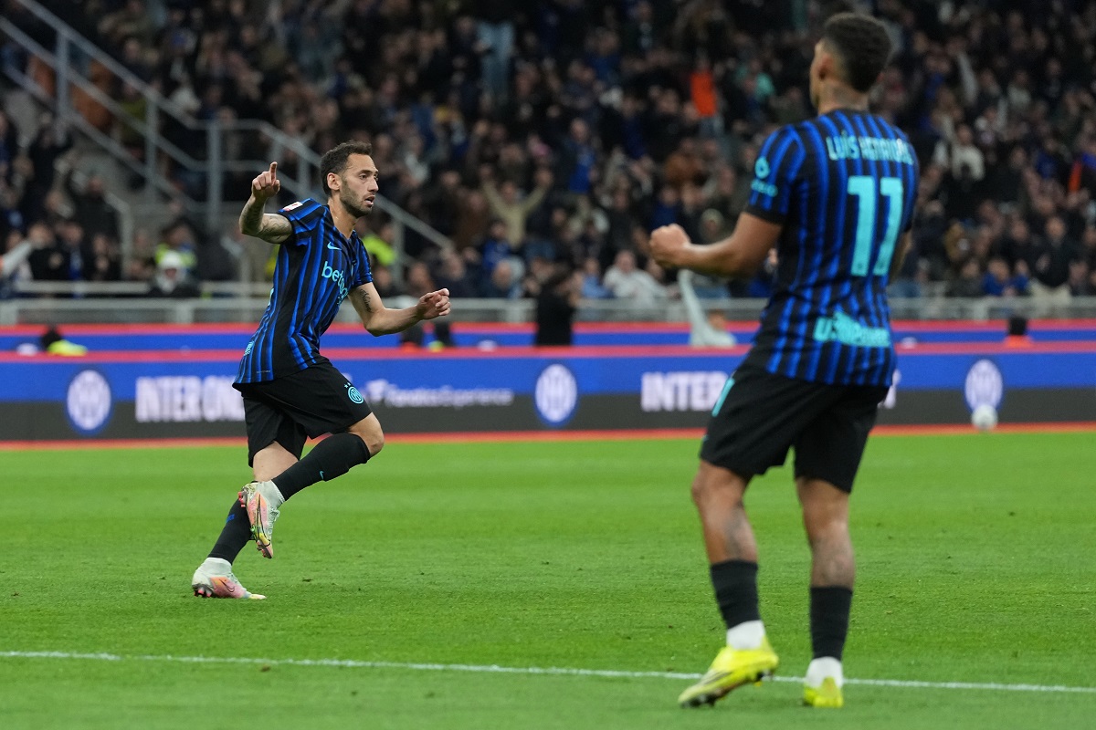 Inter Milan's Hakan Calhanoglu celebrates after scoring his side's opening goal during the Italian Cup, return-leg soccer match between Inter Milan and Como, in Milan, Italy, Tuesday, April 21, 2026. (AP Photo/Luca Bruno)