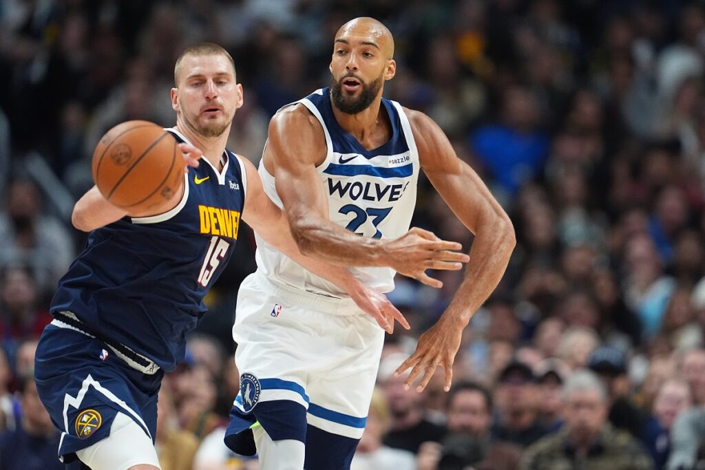 Denver Nuggets center Nikola Jokic, left, fights for control of the ball with Minnesota Timberwolves center Rudy Gobert in the second half in Game 5 of a first-round NBA playoffs basketball series Monday, April 27, 2026, in Denver. (AP Photo/David Zalubowski)