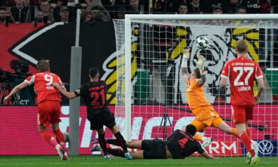 Bayern's Harry Kane scores his side's opening goal during the German Soccer Cup semifinal match between Bayer Leverkusen and Bayern Munich in Leverkusen, Germany, Wednesday, April 22, 2026. (AP Photo/Martin Meissner)