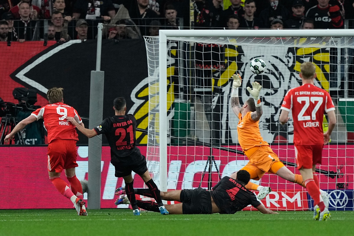 Bayern's Harry Kane scores his side's opening goal during the German Soccer Cup semifinal match between Bayer Leverkusen and Bayern Munich in Leverkusen, Germany, Wednesday, April 22, 2026. (AP Photo/Martin Meissner)