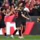 Leverkusen's Patrik Schick, centre, celebrates with Edmond Tapsoba, right, and Ibrahim Maza after scoring the opening goal during the German Bundesliga soccer match between Bayer Leverkusen and RB Leipzig in Leverkusen, Germany, Saturday, May 2, 2026. (Fabian Strauch/dpa via AP)