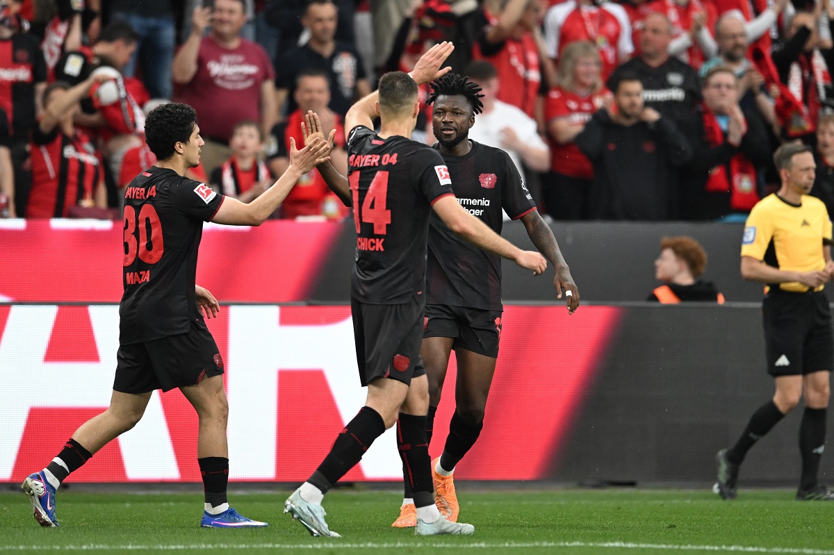 Leverkusen's Patrik Schick, centre, celebrates with Edmond Tapsoba, right, and Ibrahim Maza after scoring the opening goal during the German Bundesliga soccer match between Bayer Leverkusen and RB Leipzig in Leverkusen, Germany, Saturday, May 2, 2026. (Fabian Strauch/dpa via AP)