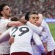 Arsenal players celebrate after scoring during the Premier League soccer match between West Ham and Arsenal in London, Sunday, May 10, 2026. (AP Photo/Ian Walton)