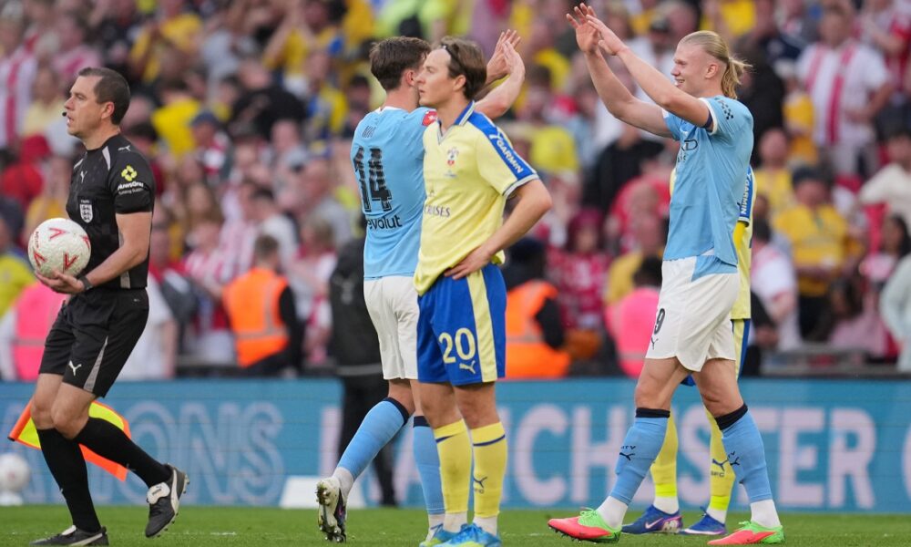 Manchester City's Nico Gonzalez, left, and Erling Haaland celebrate after the FA Cup semifinal soccer match between Manchester City and Southampton in Manchester, England, Saturday, April 25, 2026. (AP Photo/Kin Cheung)