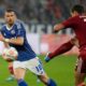 Schalke's Edin Dzeko, left, tries to block a shot from Duesseldorf's Tim Oberdorf during the German Bundesliga 2 soccer match between FC Schalke 04 and Fortuna Duesseldorf in Gelsenkirchen, Germany, Saturday, May 2, 2026. (AP Photo/Martin Meissner)