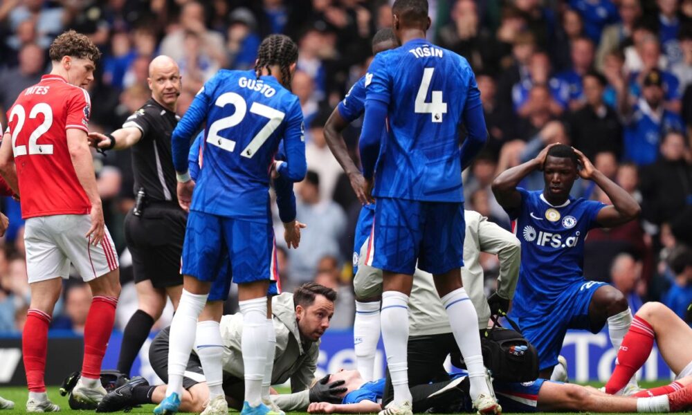 Chelsea's Jesse Derry is treated by medical staff after a clash of heads with Nottingham Forest's Zach Abbott during the English Premier League soccer match between Chelsea and Nottingham Forest in London, Monday, May 4, 2026. (John Walton/PA via AP)