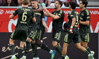Andrej Ilic, 2nd left, celebrates scoring with teammates during the Bundesliga soccer match between FSV Mainz 05 - 1. FC Union Berlin in Mainz, Germany, Sunday May 10, 2026. (Torsten Silz/dpa via AP)