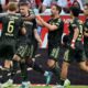 Andrej Ilic, 2nd left, celebrates scoring with teammates during the Bundesliga soccer match between FSV Mainz 05 - 1. FC Union Berlin in Mainz, Germany, Sunday May 10, 2026. (Torsten Silz/dpa via AP)