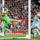 Brentford's goalkeeper Caoimhin Kelleher fails to save first goal during the Premier League soccer match between Manchester United and Brentford in Manchester, England, Monday, April 27, 2026. (AP Photo/Dave Thompson)