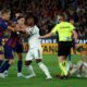 Real Madrid's Vinicius Junior argues with Barcelona players during the Spanish La Liga soccer match between FC Barcelona and Real Madrid in Barcelona, Spain, Sunday, May 10, 2026. (AP Photo/Joan Monfort)