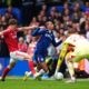 Chelsea's Joao Pedro, center, falls to the ground after pressure from Nottingham Forest's Ryan Yates during the English Premier League soccer match between Chelsea and Nottingham Forest in London, Monday, May 4, 2026. (John Walton/PA via AP)