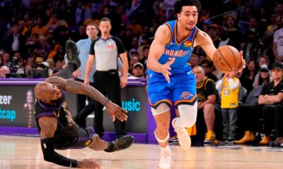 Oklahoma City Thunder guard Jared McCain, right, drives toward the basket as Los Angeles Lakers forward LeBron James falls during the second half of Game 4 in a second-round NBA basketball playoffs series Monday, May 11, 2026, in Los Angeles. (AP Photo/Mark J. Terrill)