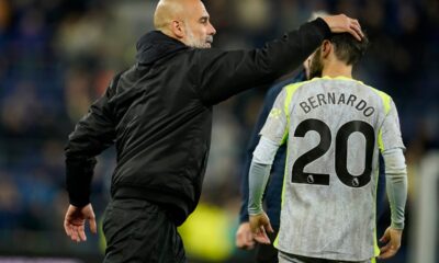 Manchester City's head coach Pep Guardiola hugs Bernardo Silva after the Premier League soccer match between Manchester City and Everton in Liverpool, England, Monday, May 4, 2026. (AP Photo/Dave Thompson)