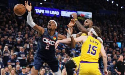Oklahoma City Thunder's Shai Gilgeous-Alexander (2) is fouled driving to the basket by Los Angeles Lakers' Austin Reaves (15) as LeBron James, right rear, follows behind on the play in the second half of Game 2 in a second-round NBA basketball playoffs series Thursday, May 7, 2026, in Oklahoma City. (AP Photo/Nate Billings)