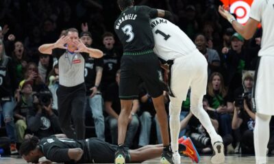 Minnesota Timberwolves center Naz Reid (11) falls to the court after he was fouled by San Antonio Spurs forward Victor Wembanyama (1) as he and forward Jaden McDaniels (3) battled for a rebound during the first half of Game 4 of an NBA basketball second-round playoffs series in Minneapolis, Sunday, May 10, 2026. (AP Photo/Abbie Parr)