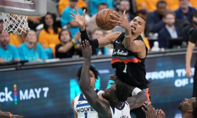 San Antonio Spurs forward Victor Wembanyama (1) reaches for the ball as Minnesota Timberwolves forward Julius Randle (30) defends during the second half in Game 1 of a second-round NBA playoffs basketball series in San Antonio, Monday, May 4, 2026. (AP Photo/Eric Gay)