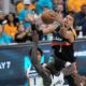 San Antonio Spurs forward Victor Wembanyama (1) reaches for the ball as Minnesota Timberwolves forward Julius Randle (30) defends during the second half in Game 1 of a second-round NBA playoffs basketball series in San Antonio, Monday, May 4, 2026. (AP Photo/Eric Gay)