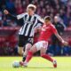 Newcastle United's Nick Woltemade, left, and Nottingham Forest's Nicolas Dominguez battle for the ball during the English Premier League soccer match between Nottingham Forest and Newcastle United in Nottingham, England, Sunday May 10, 2026. (Mike Egerton/PA via AP)