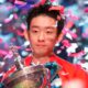 China's poses for the media with the trophy and wearing the Chinese national flag, after winning the World Snooker Championship defeating England's Shaun Murphy in Sheffield, England, Monday, May 4, 2026.(AP Photo/Ian Hodgson)