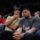 Tennis star Novak Djokovic, left, speaks with Giannis Antetokounmpo of the Milwaukee Bucks while watching a EuroLeague playoffs basketball game between Olympiacos and AS Monaco in Piraeus near Athens, Thursday, April 30, 2026. (AP Photo/Petros Giannakouris)