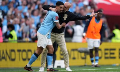 Manchester City's head coach Pep Guardiola talks to Tijjani Reijnders during the FA Cup semifinal soccer match between Manchester City and Southampton in Manchester, England, Saturday, April 25, 2026. (AP Photo/Alastair Grant)