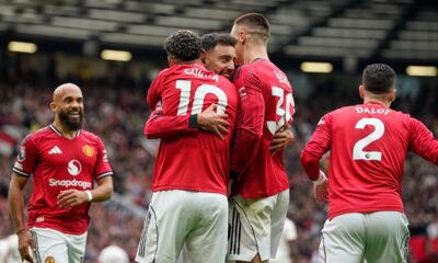 Manchester United players celebrate after scoring during the English Premier League soccer match between Manchester United and Liverpool in Manchester, England, Sunday, May 3, 2026. (AP Photo/Dave Thompson)