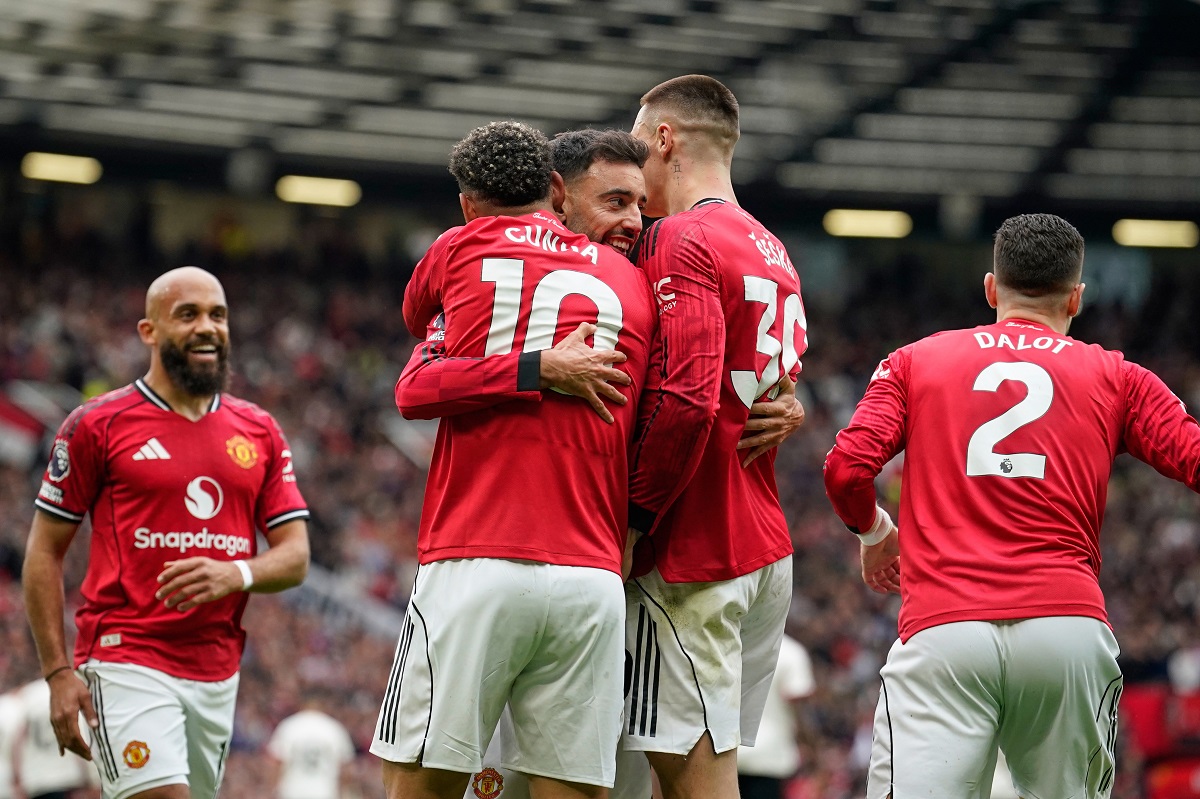 Manchester United players celebrate after scoring during the English Premier League soccer match between Manchester United and Liverpool in Manchester, England, Sunday, May 3, 2026. (AP Photo/Dave Thompson)