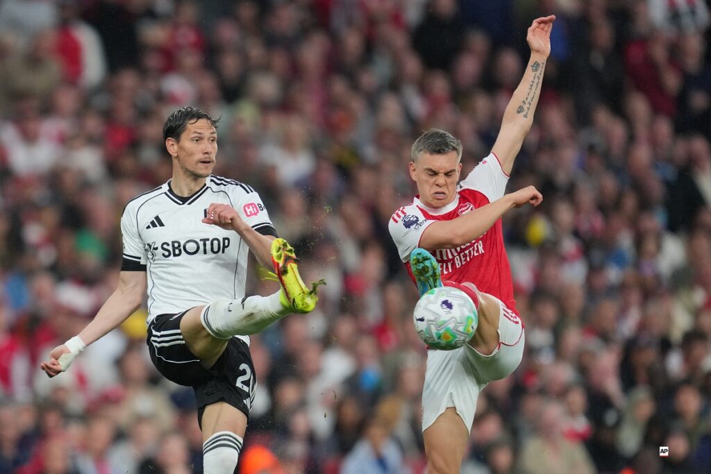 Fulham's Sasa Lukic, left, and Arsenal's Leandro Trossard in action during the English Premier League soccer match between Arsenal and Fulham in London, England, Saturday, May 2, 2026. (AP Photo/Kin Cheung)